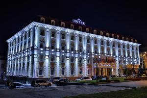 a large white building with lights on it at night at Hotel Ukraine Rivne in Rivne