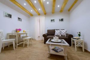 a living room with a couch and a table at Leona Apartments in Dubrovnik