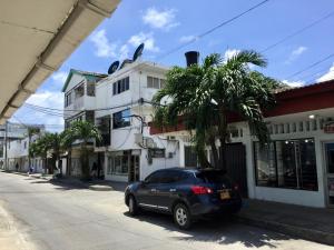 a car parked on a street next to a building at Edificio águila in San Andrés