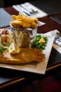 a plate of food with french fries and chips at Bannockburn Inn in Helmsdale