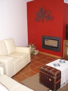 a living room with a couch and a fireplace at Quinta Vale do Nox in Serrazes