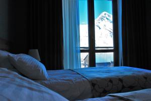 Postelja oz. postelje v sobi nastanitve Sunshine Kazbegi