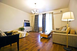 a living room with a couch and a tv at Lakshmi Apartment Tverskaya 4 in Moscow