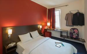 Postel nebo postele na pokoji v ubytování Dodo Hotel