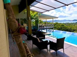 a view of a resort with a swimming pool at Amazing ocean view Villa vista Chocoyas in Playa Flamingo