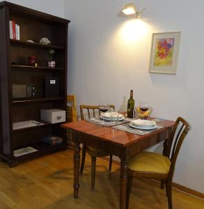 a dining room table with two chairs and a bottle of wine at Charming, central, spacious apartment in Innsbruck +12 photos