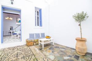 a living room with a table and a vase with a plant at The red door in Koskinou in Koskinou