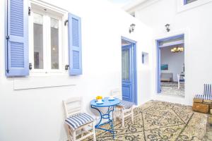 a patio with a table and chairs and a door at The red door in Koskinou in Koskinou