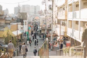 a group of people walking down a busy city street at hanare in Tokyo