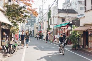 a group of people riding bikes down a city street at hanare in Tokyo