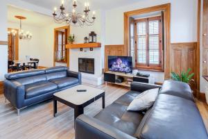 a living room with a couch and a fireplace at Les Lofts St-Vallier - Par Les Lofts Vieux Québec in Quebec City