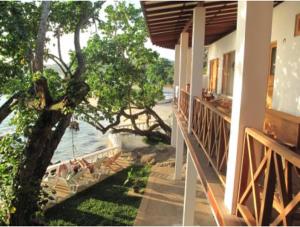 a balcony of a house with a view of the water at Sun N Sea Hotel in Unawatuna