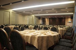 a conference room with tables and chairs with white table cloth at Fuller Hotel in Alor Setar