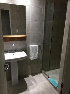 a bathroom with a sink and a shower at Hosteria Kupanaka in Ushuaia +57 photos