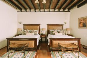 Ένα ή περισσότερα κρεβάτια σε δωμάτιο στο Casona de los Sapos Hotel Boutique +47 φωτογραφίες