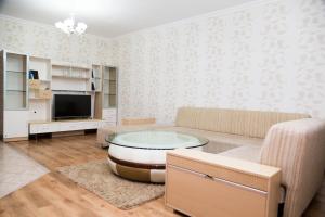 a living room with a couch and a table at Academic Apartments in Almaty