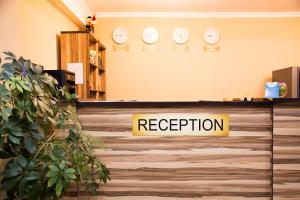 a reception desk with a sign that reads reception at Academic Apartments in Almaty