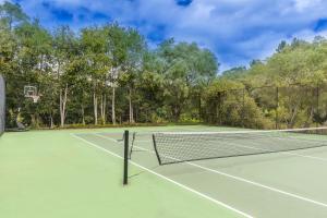 
a tennis court with a tennis racket on it at Grand Mercure Basildene Manor in Margaret River Town
