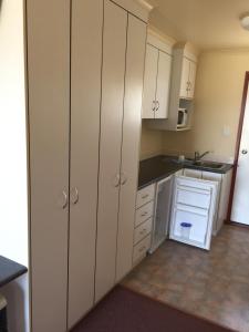 a kitchen with white cabinets and a sink at Rangemore Estate in Maclagan