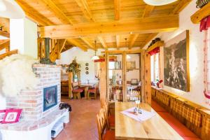 a living room with a brick fireplace and a table at Biobauernhof Lacken in Strohmarkt