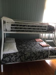 two bunk beds in a room with a bed at Rangemore Estate in Maclagan