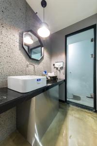a bathroom with a sink and a mirror at Anyang Boutique Hotel AMA in Anyang