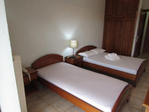 Postel nebo postele na pokoji v ubytování Balogiannis Hotel