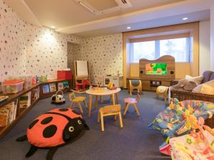 a childrens room with a table and a bed and a table and chairs at Shimahana in Sumoto