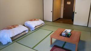 Postel nebo postele na pokoji v ubytování Itoen Hotel Hakone Yumoto + 21 fotografií