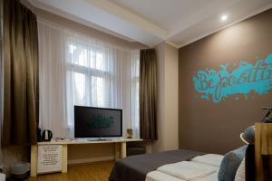 TV a/nebo společenská místnost v ubytování Hotel Carpe Diem