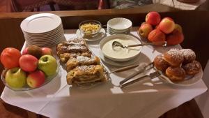 a table topped with different types of pastries and fruit at Haus Evi in Termeno