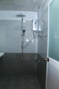 a bathroom with a shower with a shower head at Serene Beach Hotel in Dickwella