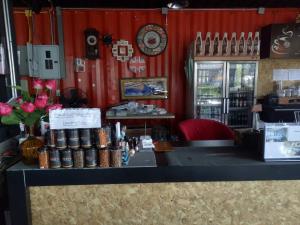 a counter in a store with a red wall at Ma der bua hotel in Udon Thani