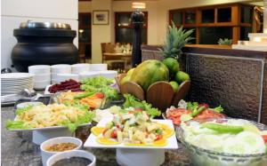 a buffet with plates of food on a table at Sterling Corbett in Garjia