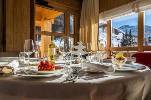 a table topped with plates of food on top of a wooden table at Le Yule Hotel & Spa in Val-d'Isère