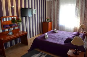 Postel nebo postele na pokoji v ubytování Hotel Gregor