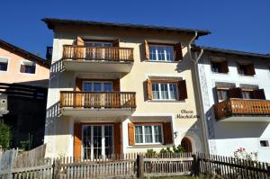 a building with a fence in front of it at Minchületta 1 in Scuol