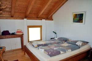 um quarto com uma cama num quarto com tectos em madeira em Suotchalchera 5 em Ftan