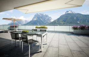 a balcony with a table and a view of mountains at La Perla A1 in Scuol