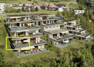 an aerial view of a building with a yellow rectangle at La Perla A1 in Scuol