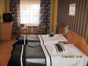 Postel nebo postele na pokoji v ubytování Hotel Gregor