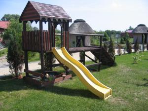 a playground with a slide and a gazebo at Hotel Gregor in Pszczółki