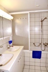 a white bathroom with a sink and a shower at Plazzöl Suol Nr. 5 in Scuol