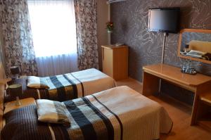Postel nebo postele na pokoji v ubytování Hotel Gregor