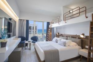 a hotel room with a bed and a view of the ocean at Lordos Beach Hotel & Spa in Larnaca +37 photos
