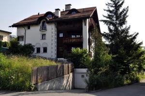 a white house with a brown roof at Chasa Sager 2 in Scuol