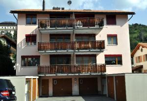 a building with balconies on the side of it at Pütvia E6 in Scuol