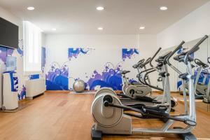 a gym with cardio equipment in a room at Eurostars Roma Aeterna in Rome