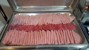 a bunch of uncooked meat in a pan at Water's Edge Hotel in Birżebbuġa
