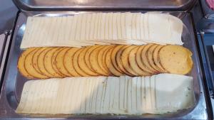 a plastic container filled with cheese and banana slices at Water's Edge Hotel in Birżebbuġa